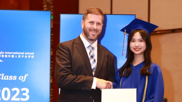 tianjin international school head of school ryan witt with graduating female student