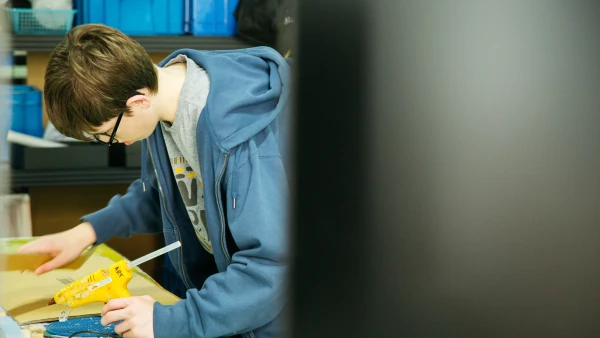 male student working hard at tianjin international school about arts and crafts