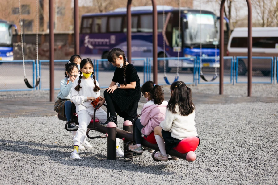 young female students playing outside at tianjin international school
