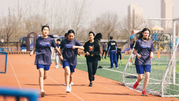 female secondary students running outside tianjin international school news and sport events