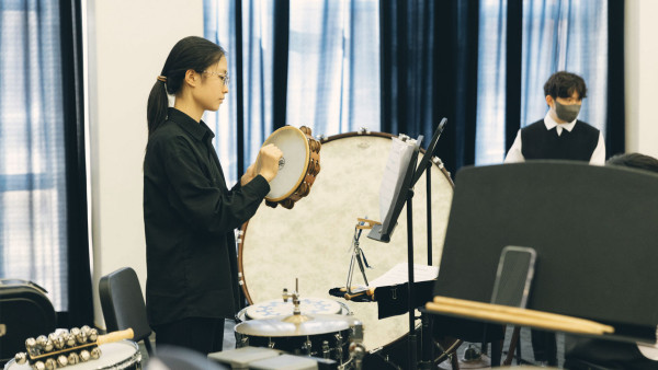 female student playing the tambourine for tianjin international school enroll process