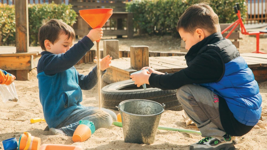 tianjin international school learning students playing outside with sand